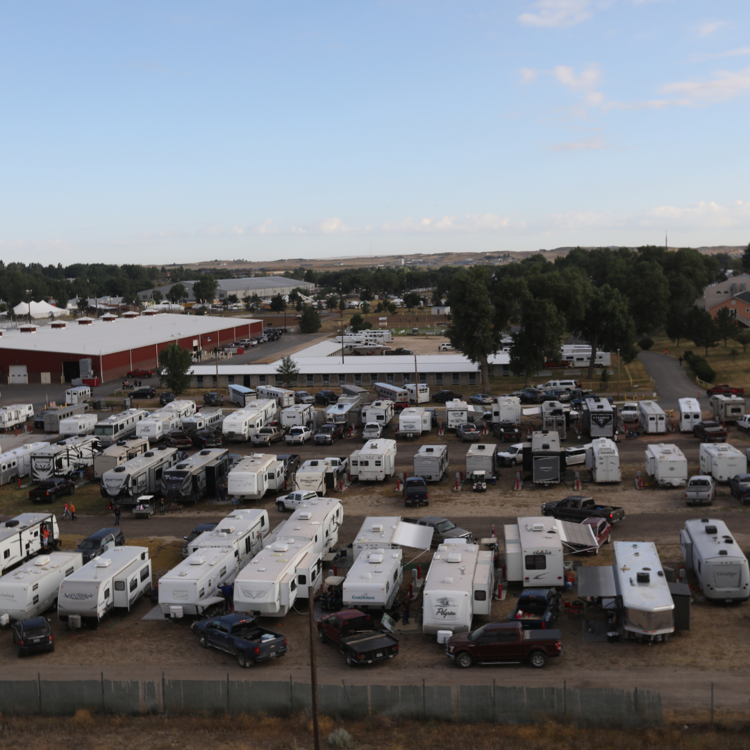 This photo contains an overhead birds eye view of the Wyoming State Fair RV Park during the fair. There are three double-sided rows of campers.